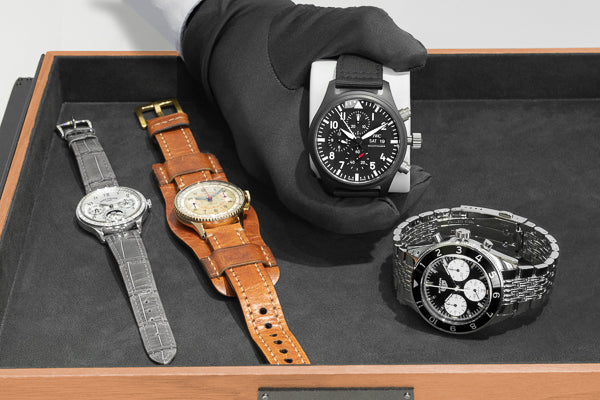 Person displaying various pre-owned watches