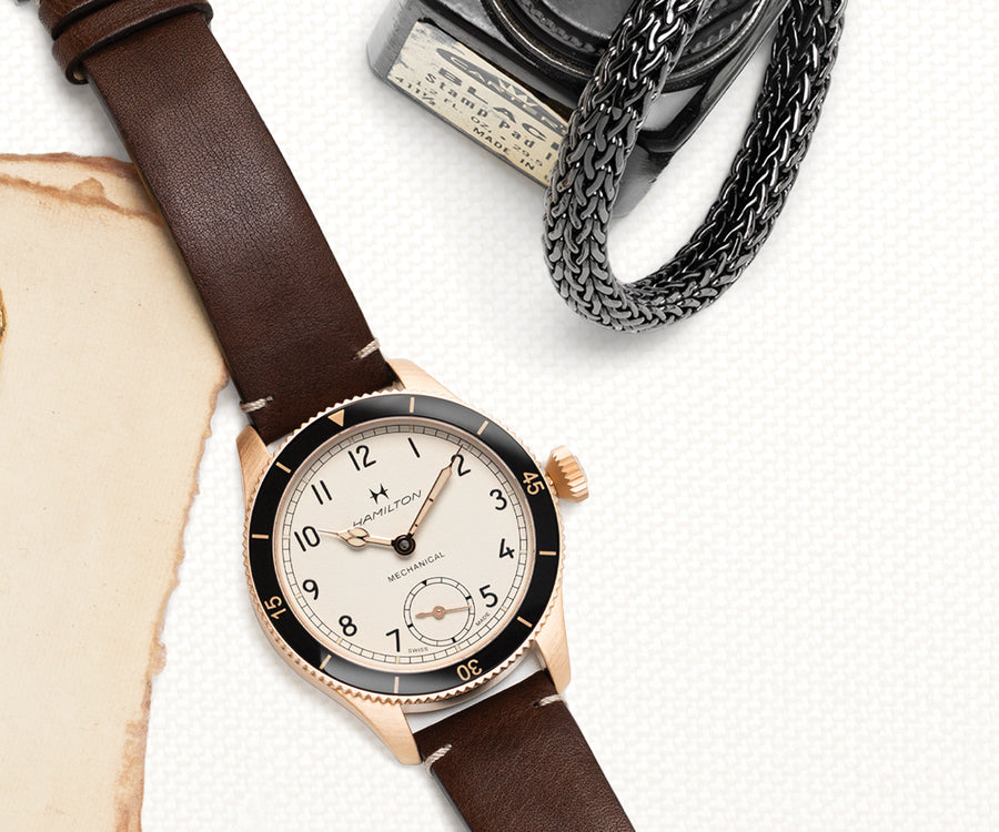 Crop from the Father's Day layout in the 2026 Spring Catalog showing a Hamilton watch and a John Hardy bracelet.