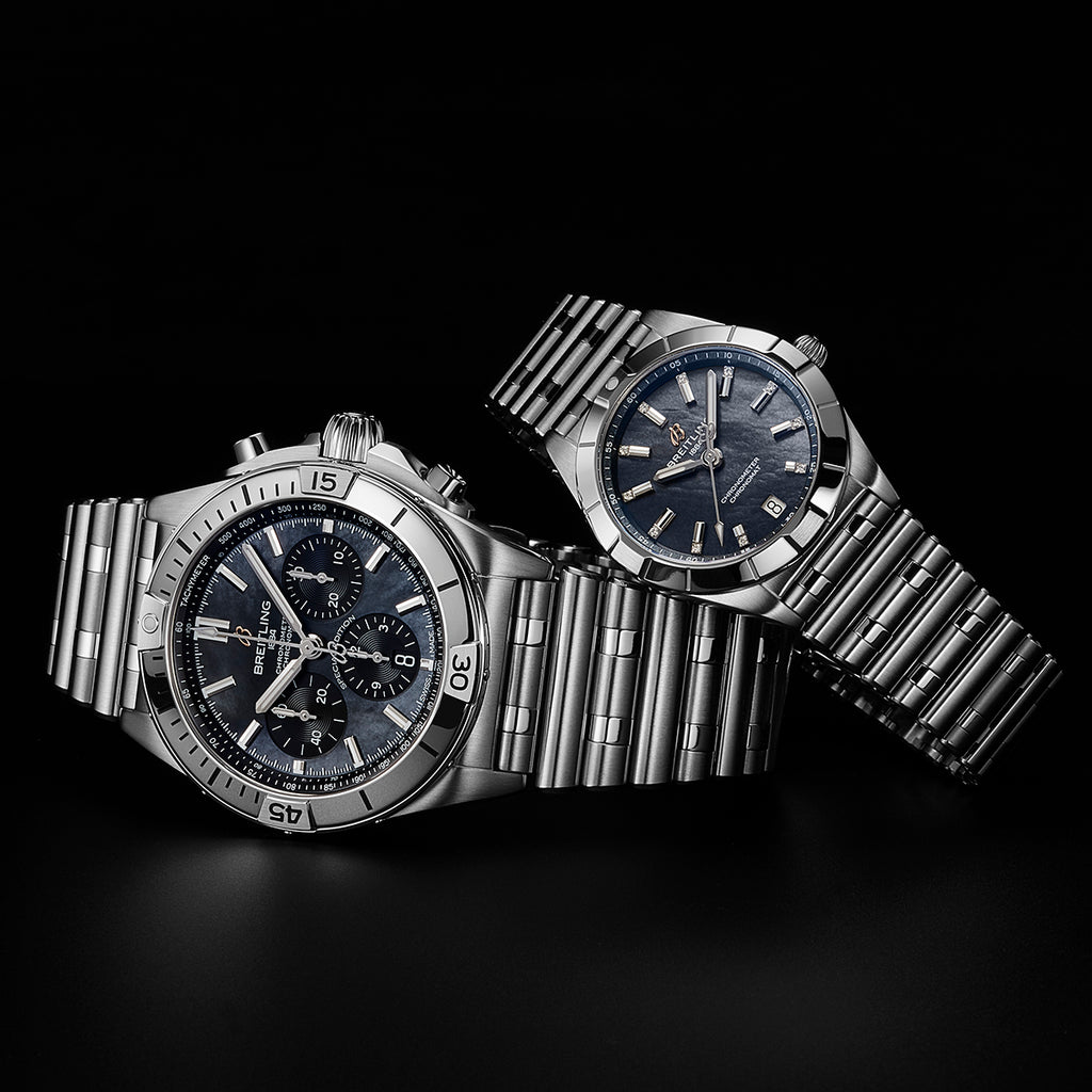 One men's and one women's Breitling Chronomat watch stacked together. 