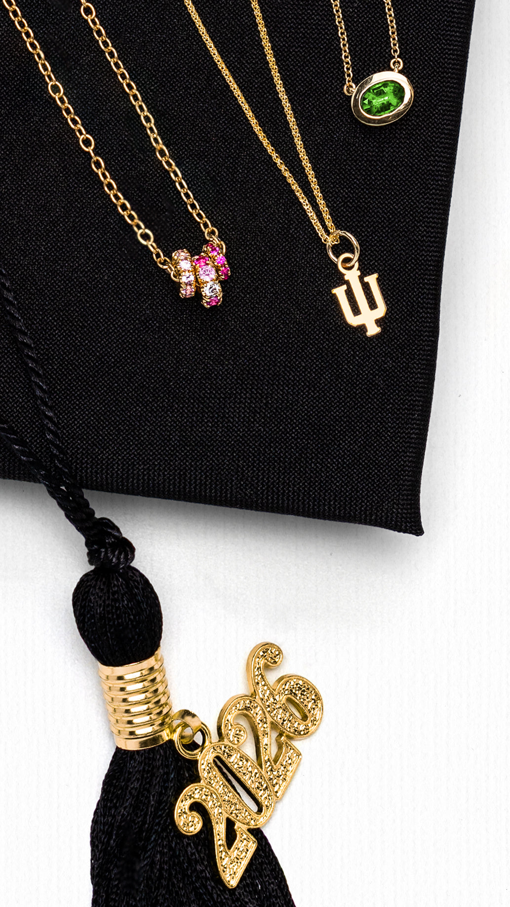 Crop of the graduation gifts for her spread in the Reis-Nichols Spring Catalog. Jewelry is shown on a graduation cap with the year "2026" on the tassel.