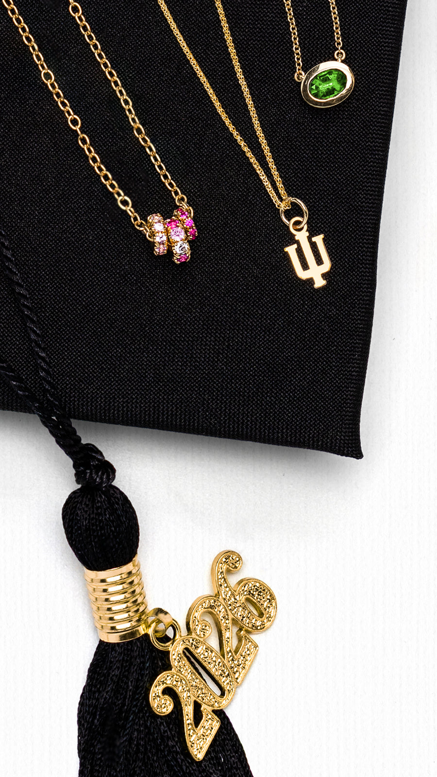 Crop of the graduation gifts for her spread in the Reis-Nichols Spring Catalog. Jewelry is shown on a graduation cap with the year "2026" on the tassel.