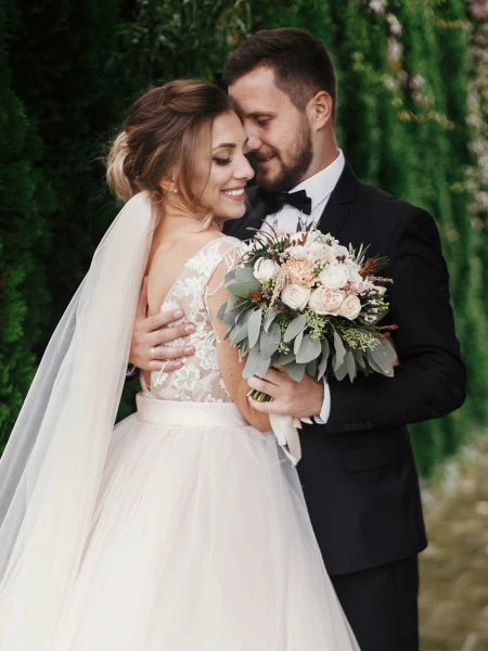 Image of Bride and Groom holding each other- Shop Engagement and Bridal Jewelry at Reis-Nichols